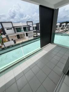 a balcony with a swimming pool on a building at Exclusive Changlun Room in Bukit Kayu Hitam