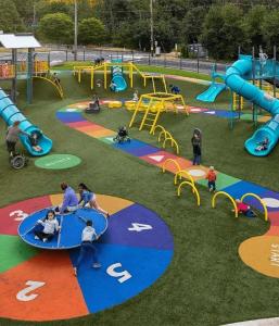 a group of people playing in a playground at himalayan hotel in Jogīkuti