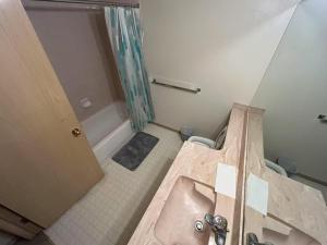 a bathroom with a bed and a tub and a sink at Lower Suite- 10 minutes away from airport in Calgary +26 photos