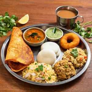 a tray of food on a table with a plate of food at Hotel The Luxury F S Bliss Most Premium Rooms NearTaj Mahal !!! Best Stay In Agra in Agra