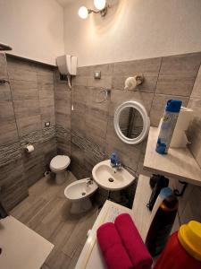 a bathroom with a sink and a toilet and a mirror at Stella Marys Nord in Olbia +20 photos