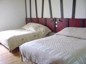 Un ou plusieurs lits dans un hébergement de l'établissement La Ferme du Manoir Etretat