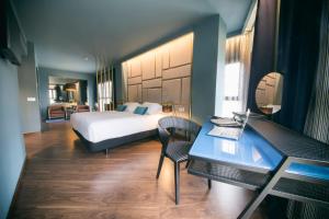 a bedroom with a bed and a desk with a laptop at Pamplona Catedral Hotel in Pamplona