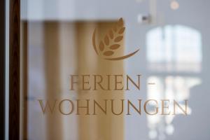 a glass door with a sign that reads eighteen wonders at LAKE-LOFT APARTMENT's direkt im Hafen in Romanshorn +21 photos