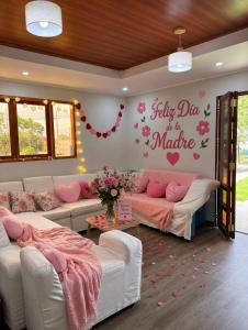 a living room with two couches and a sign that says silly day is in at Casa La Herencia in Huaral +32 photos