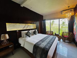 a bedroom with a large bed and a large window at Cempaka Guesthouse in Silebeng +50 photos