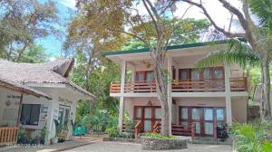 a house with a balcony on top of it at Republika Beach Resort in San Juan