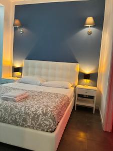 a bedroom with a bed with a blue wall at Luxury central apartments in Pisa