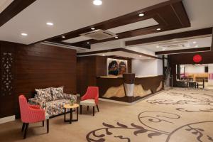 a lobby with a couch and chairs and a table at Ginger Katra in Katra