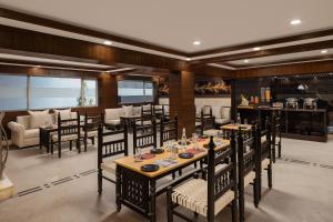 a dining room with tables and chairs in a restaurant at Ginger Katra in Katra