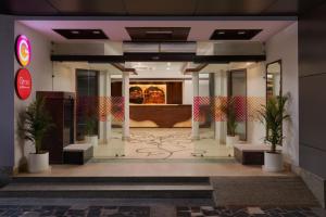 a lobby of a building with potted plants at Ginger Katra in Katra