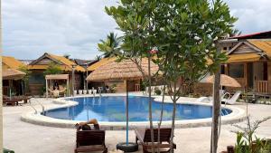 a person laying in chairs next to a swimming pool at Koh Rong New Beach Resort in Koh Rong Island