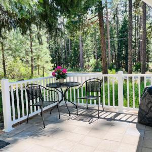 a table with two chairs and a vase of flowers on a porch at Dafna, Unit 8 in Cromberg