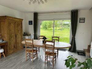 a dining room with a table and chairs and a window at Les Chambres de Pascaline in Arrest +15 photos
