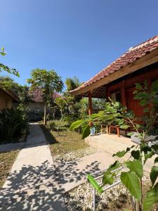 a house with a walkway next to a building at Melody Surf Ekas Lombok in Ekas