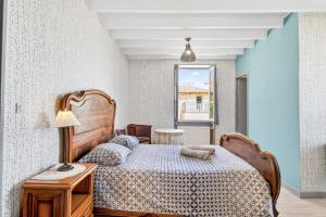 a bedroom with a bed and a table with a lamp at Chambres D'hôtes Des 17 Clochers - in Saint-Vérand