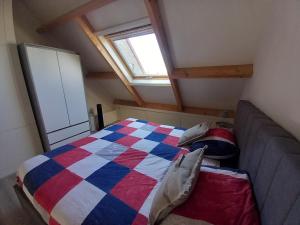 a bedroom with a bed in a room with a window at molenpad in Meliskerke
