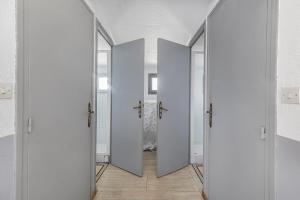a hallway with four doors in a room at Chambres D'hôtes Des 17 Clochers - in Saint-Vérand +46 photos