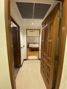 a hallway with a door leading to a bedroom at Me Design khao yai in Ban Pang Kae