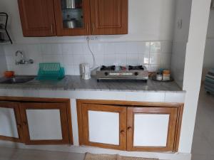 a kitchen counter with a stove and a sink at Villa La Casita in Cavelossim