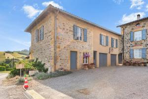 a large stone house with a driveway in front of it at Chambres D'hôtes Des 17 Clochers - in Saint-Vérand