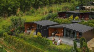 two people standing in front of a house at THUNWA the CAMPSITE in Ban Khao Ya Nua