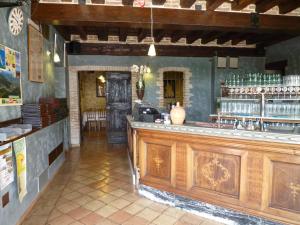 a bar in a restaurant with a counter in a room at Hotel Antica Abbazia in Borso del Grappa