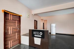 a lobby with a hotel sign on a door at Super Hotel O Bharat Institute of Engineering Hyderabad Formerly Blue Petals in Hyderabad
