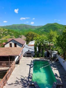 an overhead view of a swimming pool with mountains in the background at Dilijan Rest - Comfortable rooms & Pool in Dilijan