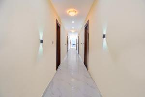 a hallway of a house with white walls and doors at Super Collection O MIDC Pimpari Pune Formerly SK Palace in Chinchwad