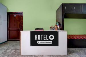 a hotel sign sitting on top of a counter in a room at Hotel O Singar Nagar Metro Station Lucknow Formerly Highway Inn in Alambagh
