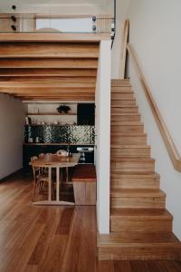 a staircase leading up to a kitchen with a table at View Street Studios - Yarri in Albany