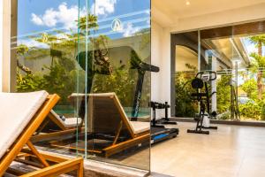 a room with a gym with a glass wall at Arkadewi Boutique Hotel Prawirotaman in Yogyakarta