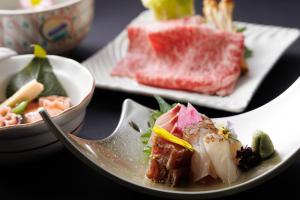 a plate of food with sushi on a table at ホテルグランリゾート蓼科 in Chino