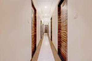 a corridor of a house with white walls and a long hallway at Collection O Crawford Market Formerly Al Ibrahim Hotel in Mumbai