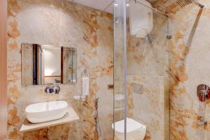 a bathroom with a sink and a shower at Townhouse Oak Sector 31 Noida in Noida