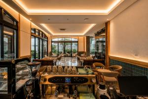a restaurant with a stove in a room with chairs at Arkadewi Boutique Hotel Prawirotaman in Yogyakarta