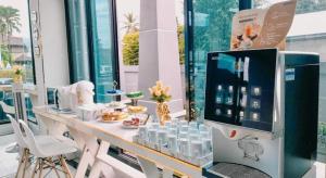 a room with a counter with a lot of products on it at Aiyara Riverine Hotel, Nakhon Phanom in Ban Nong Puk