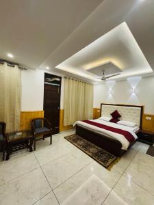 a bedroom with a king sized bed and a desk at Green tree house in Dharmsāla