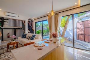 a living room with a couch and a table at Sanara Oasis Villa in Canggu