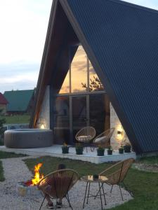 a group of chairs and a fire pit in front of a house at Villa Silence in Žabljak