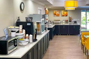 a kitchen with a counter with food on it at Comfort Suites Salisbury I-85 in Salisbury +57 photos