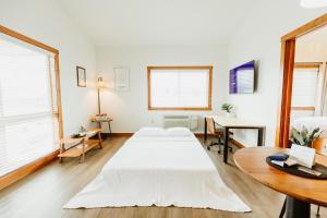 a bedroom with two beds and a table at Kintla Ridge Suite wFull kitchen and WasherDryer in Kalispell