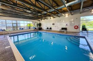 a large pool with blue water in a building at Quality Inn & Conference Centre Kingston Central in Kingston