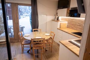 a kitchen and dining room with a table and chairs at TMB Tour du Mont-Blan in Les Contamines-Montjoie
