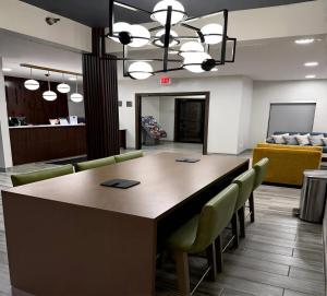 a conference room with a large wooden table and chairs at Comfort Inn & Suites Harvey - Chicago Southland in Harvey