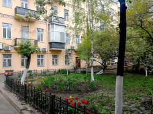 a building with a flower garden in front of it at Home Hotel Apartments on Zoloti Vorota in Kyiv