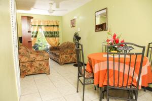 a living room with a table and a couch at Angel's Apartment Jamaica in Kingston