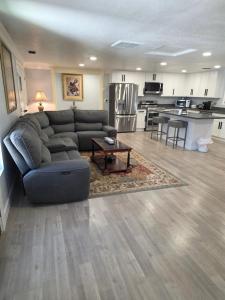 a living room with a couch and a kitchen at Cozy SeaTac home in SeaTac