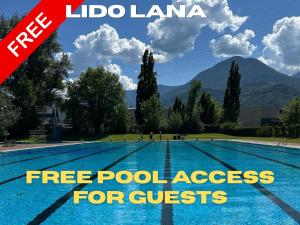 a swimming pool with the text free pool access for guests at Hotel Cavallino s'Rössl in Merano